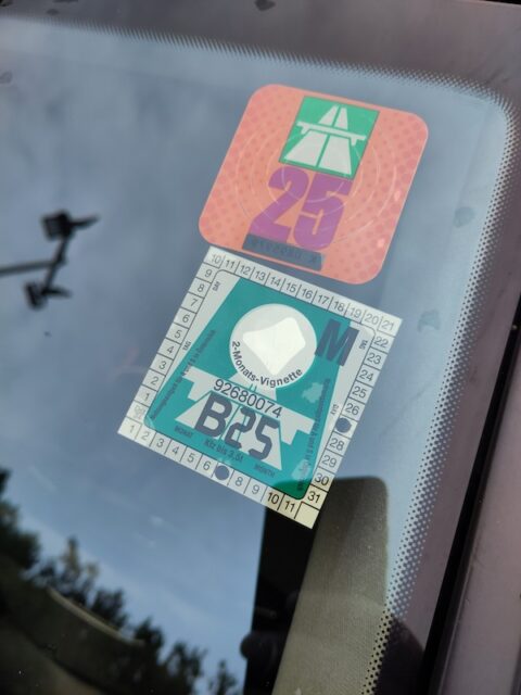 Two window badges for road tolls, Swiss and Austrian.
